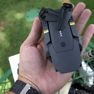 guy holds Black Falcon Drone in palm