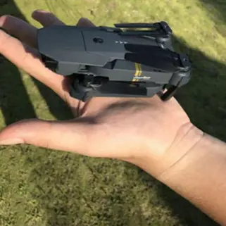 guy holds Black Falcon Drone in palm